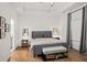 Serene main bedroom featuring a tray ceiling, large bed, and natural light at 127 Harlow Cir, Roswell, GA 30076