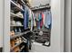 Well-organized walk-in closet featuring multiple shelves and racks for maximum storage efficiency at 127 Harlow Cir, Roswell, GA 30076