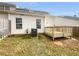 Backyard featuring a small wooden deck, fence, and grassy yard at 2341 Wellington Cir, Lithonia, GA 30058