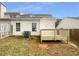 Backyard featuring a small wooden deck, fence, and grassy yard at 2341 Wellington Cir, Lithonia, GA 30058