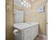 Bathroom featuring an oversized mirror, decorative lighting, and a white vanity for storage at 3591 Lochwolde Ln, Snellville, GA 30039