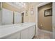 Bathroom featuring white vanity, decorative mirror, and a doorway that leads to a water closet at 3591 Lochwolde Ln, Snellville, GA 30039