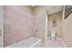 Bathroom with a tiled shower and a toilet against a neutral colored wall at 3591 Lochwolde Ln, Snellville, GA 30039