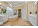 Elegant bathroom with soaking tub, tiled shower, double vanity and warm neutral palette at 3591 Lochwolde Ln, Snellville, GA 30039