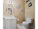 Elegant powder room featuring a white vanity, oval mirror, neutral walls, and stylish fixtures at 3591 Lochwolde Ln, Snellville, GA 30039