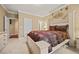 Bedroom features soft carpet and a decorative headboard with access to the en-suite bathroom at 3591 Lochwolde Ln, Snellville, GA 30039