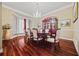 Formal dining room featuring hardwood floors, a chandelier, and elegant decor at 3591 Lochwolde Ln, Snellville, GA 30039