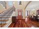 Grand foyer with hardwood floors, elegant staircase, and a glimpse of the formal dining room at 3591 Lochwolde Ln, Snellville, GA 30039