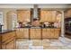 A lovely kitchen featuring light brown cabinets and dark granite countertops at 3591 Lochwolde Ln, Snellville, GA 30039