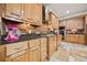 A kitchen with light brown cabinets, granite countertops, and stainless appliances at 3591 Lochwolde Ln, Snellville, GA 30039