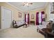 Cozy living room features floral furniture, carpeted floors, and natural light from the windows at 3591 Lochwolde Ln, Snellville, GA 30039