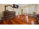 Charming main bedroom with hardwood flooring, a tray ceiling, two lounge chairs and a TV at 3591 Lochwolde Ln, Snellville, GA 30039