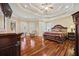 Spacious main bedroom with tray ceiling, hardwood floors, sitting area and elegant furnishings at 3591 Lochwolde Ln, Snellville, GA 30039