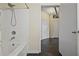 Bathroom featuring a shower-tub combo, white tile, and a view into the adjacent hallway at 800 Peachtree Ne St # 8508, Atlanta, GA 30308