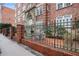 Beautiful brick apartment building with manicured courtyard and wrought iron fence at 800 Peachtree Ne St # 8508, Atlanta, GA 30308