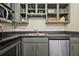 Kitchen counter area with stainless steel appliances and gray cabinets above and below the countertops at 800 Peachtree Ne St # 8508, Atlanta, GA 30308