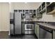 Modern kitchen with stainless steel appliances, granite countertops, and well-lit gray cabinetry at 800 Peachtree Ne St # 8508, Atlanta, GA 30308