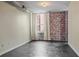 Bright living room features exposed brick wall, large window with bright natural light, and concrete flooring at 800 Peachtree Ne St # 8508, Atlanta, GA 30308