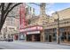 Exterior view of the historical theater on a commercial street, with flags and a marquee at 800 Peachtree Ne St # 8508, Atlanta, GA 30308