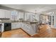 Well-lit kitchen with granite countertops and hardwood floors at 1845 Habersham Trce, Cumming, GA 30041