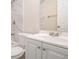 Bright bathroom featuring a white vanity and a marble-tiled shower with modern fixtures at 3005 Hidden Dr, Lawrenceville, GA 30044