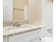 Bathroom featuring a granite vanity top, white cabinetry, and a large mirror at 3005 Hidden Dr, Lawrenceville, GA 30044