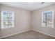 Bedroom with a neutral carpet, natural light, and two windows providing a bright space at 3005 Hidden Dr, Lawrenceville, GA 30044