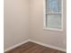 Bedroom with a wood floor, neutral walls, and a bright window with blinds at 3005 Hidden Dr, Lawrenceville, GA 30044