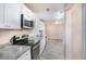 Well-lit kitchen featuring stainless steel appliances, granite countertops, and modern white cabinetry at 3005 Hidden Dr, Lawrenceville, GA 30044