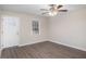 Bright living room featuring hardwood floors, a white front door, a ceiling fan, and natural light at 3005 Hidden Dr, Lawrenceville, GA 30044