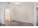 Neutral-toned living room with hardwood floors and views into the kitchen and hallway at 3005 Hidden Dr, Lawrenceville, GA 30044