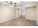 Bedroom with a carpet, a ceiling fan, and a bathroom with a large mirror at 3005 Hidden Dr, Lawrenceville, GA 30044