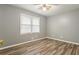 Bedroom features gray walls, wood-look floors, ceiling fan and window at 1495 Harbour Oaks Rd, Tucker, GA 30084