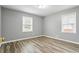 Bedroom features gray walls, wood-look floors, and two windows at 1495 Harbour Oaks Rd, Tucker, GA 30084