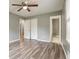 Bedroom with hardwood flooring, walk-in closet, bathroom entry, and ceiling fan at 1495 Harbour Oaks Rd, Tucker, GA 30084