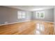 Spacious living room with hardwood floors, ample natural light and modern light fixture at 1495 Harbour Oaks Rd, Tucker, GA 30084