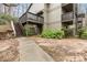 Multi-level exterior view of apartment building with stairs and mature landscaping at 2710 Cumberland Se Ct # 2710, Smyrna, GA 30080