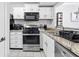 Functional kitchen with stainless steel appliances, granite countertops, and white cabinets at 2710 Cumberland Se Ct # 2710, Smyrna, GA 30080