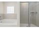 A bright bathroom with tub and tiled shower stall at 4098 Fairlady Ct, Kennesaw, GA 30144