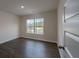 This bedroom features dark floors and a large window for natural light at 4098 Fairlady Ct, Kennesaw, GA 30144