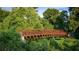 Scenic view of a brown metal bridge surrounded by vibrant green foliage, creating a lush, natural setting at 4098 Fairlady Ct, Kennesaw, GA 30144