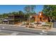 A well-designed building featuring brick and modern architecture with a beautifully landscaped garden and a street view at 4098 Fairlady Ct, Kennesaw, GA 30144