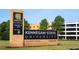 Kennesaw State University sign with lush greenery and a modern building in the background under a clear blue sky at 4098 Fairlady Ct, Kennesaw, GA 30144