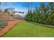 Large backyard with a manicured lawn, privacy fence, and mature landscaping at 400 Laurel Chase Ct, Atlanta, GA 30327