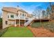 Expansive backyard featuring a deck, stairs, lush landscaping, and manicured lawn at 400 Laurel Chase Ct, Atlanta, GA 30327