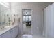 Bathroom with vanity and mirror, with a doorway view into a living area, and a shower with a white curtain at 400 Laurel Chase Ct, Atlanta, GA 30327