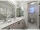 Clean bathroom with a white vanity, large mirror, and a view into the toilet room at 400 Laurel Chase Ct, Atlanta, GA 30327