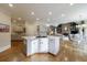 Open kitchen with large island with cooktop, light wood cabinets, and hardwood floors at 400 Laurel Chase Ct, Atlanta, GA 30327