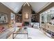 Cozy living room with a fireplace, built-in bookshelves, and bright, natural light at 400 Laurel Chase Ct, Atlanta, GA 30327