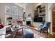 Comfortable living room featuring large windows, a fireplace, and custom built-in shelving at 400 Laurel Chase Ct, Atlanta, GA 30327